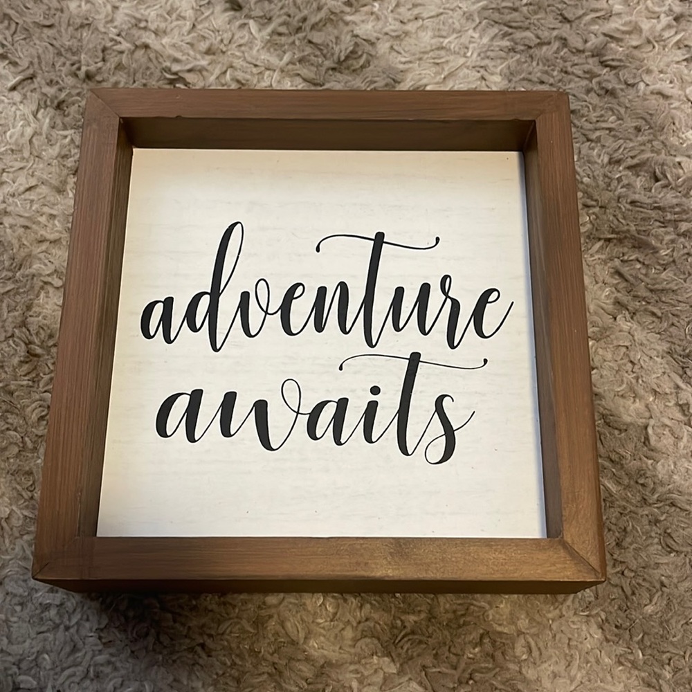 Wall sign “Adventure Awaits”